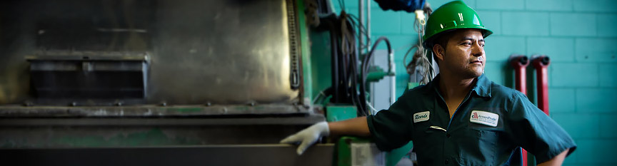 Image of man feeding clothing machine