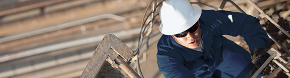 Industrial worker climbing ladder